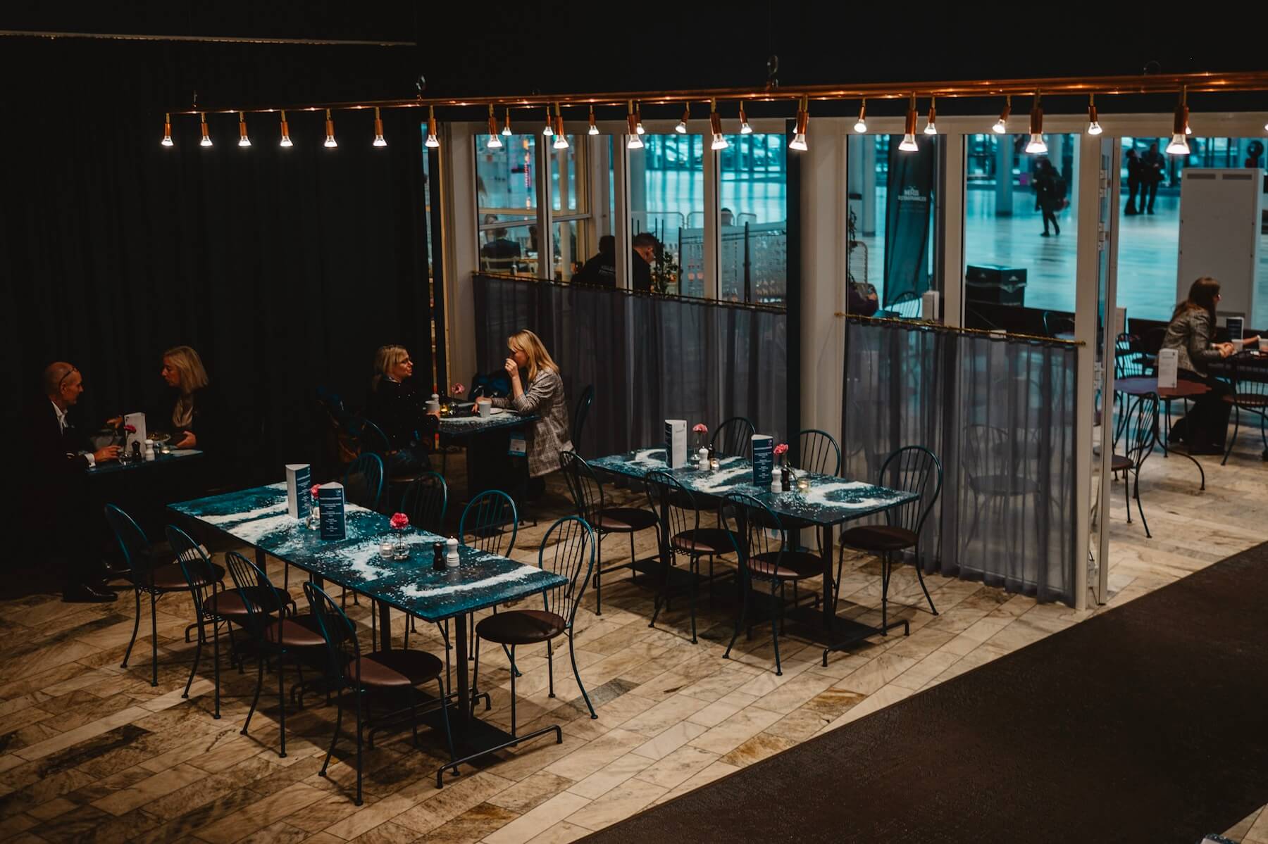 Nordic Bistro evening atmosphere at Stockholmsmässan — recycled fishing net tabletops by Interesting Times Gang, design by Ingridsdotter x Jonas Bohlin.